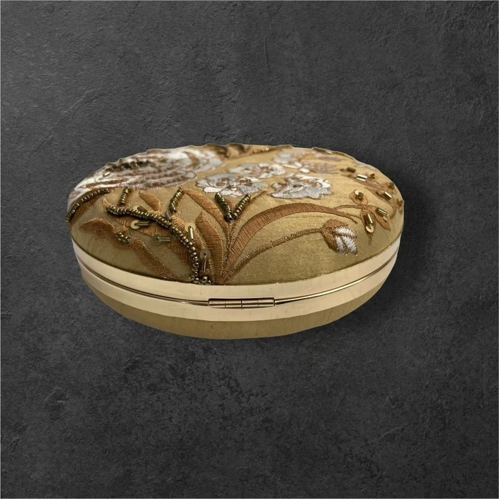 CLUTCHES AND MORE Beige round floral clutch with sequins and bead work.